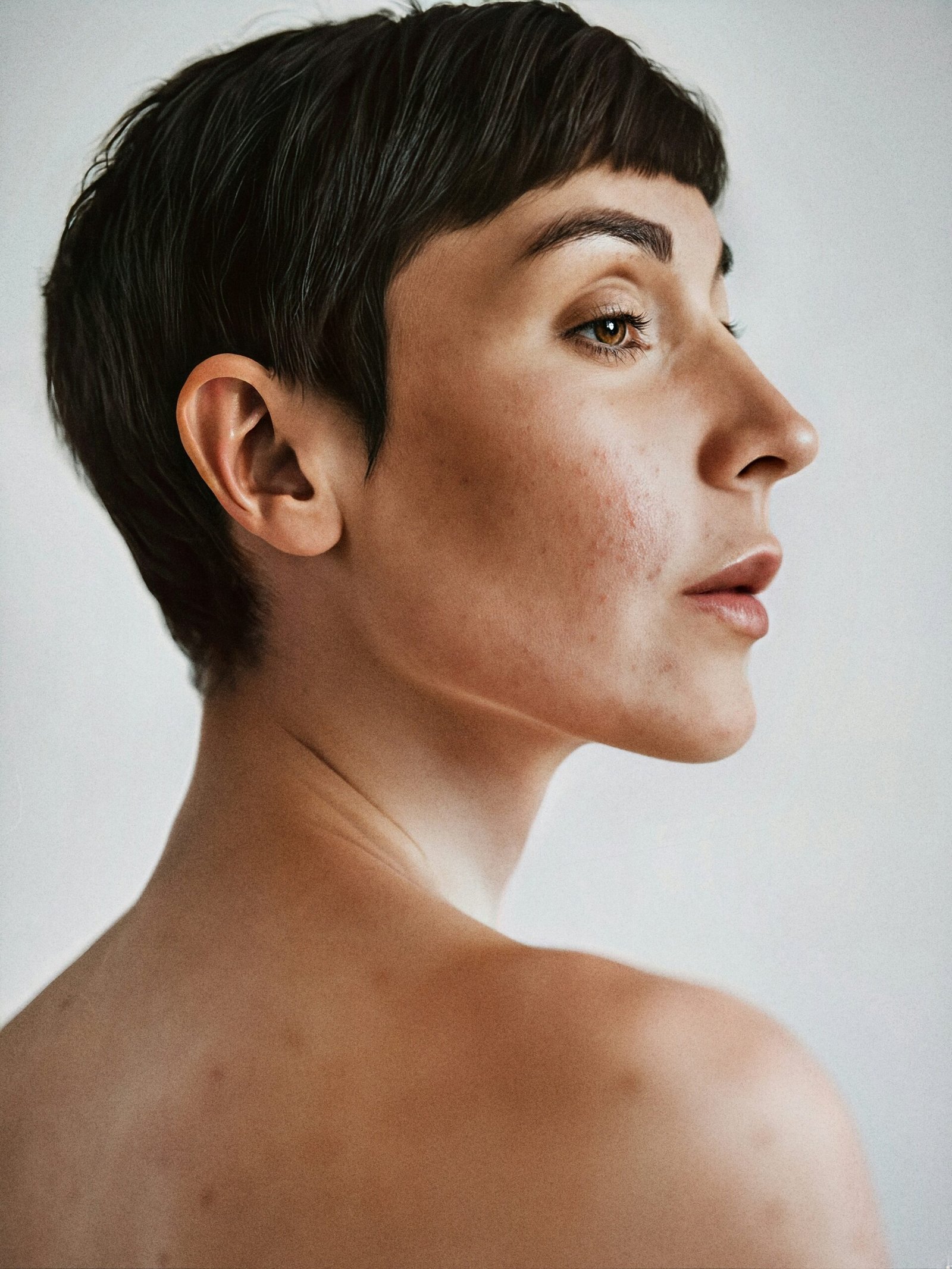ai generated portrait of Ai generated portrait of female model with short dark hair and bare shoulders