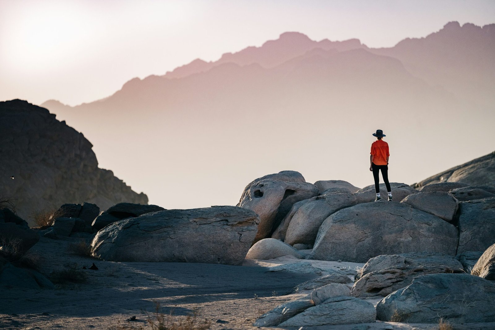 a person standing on a person standing on top of a large rock