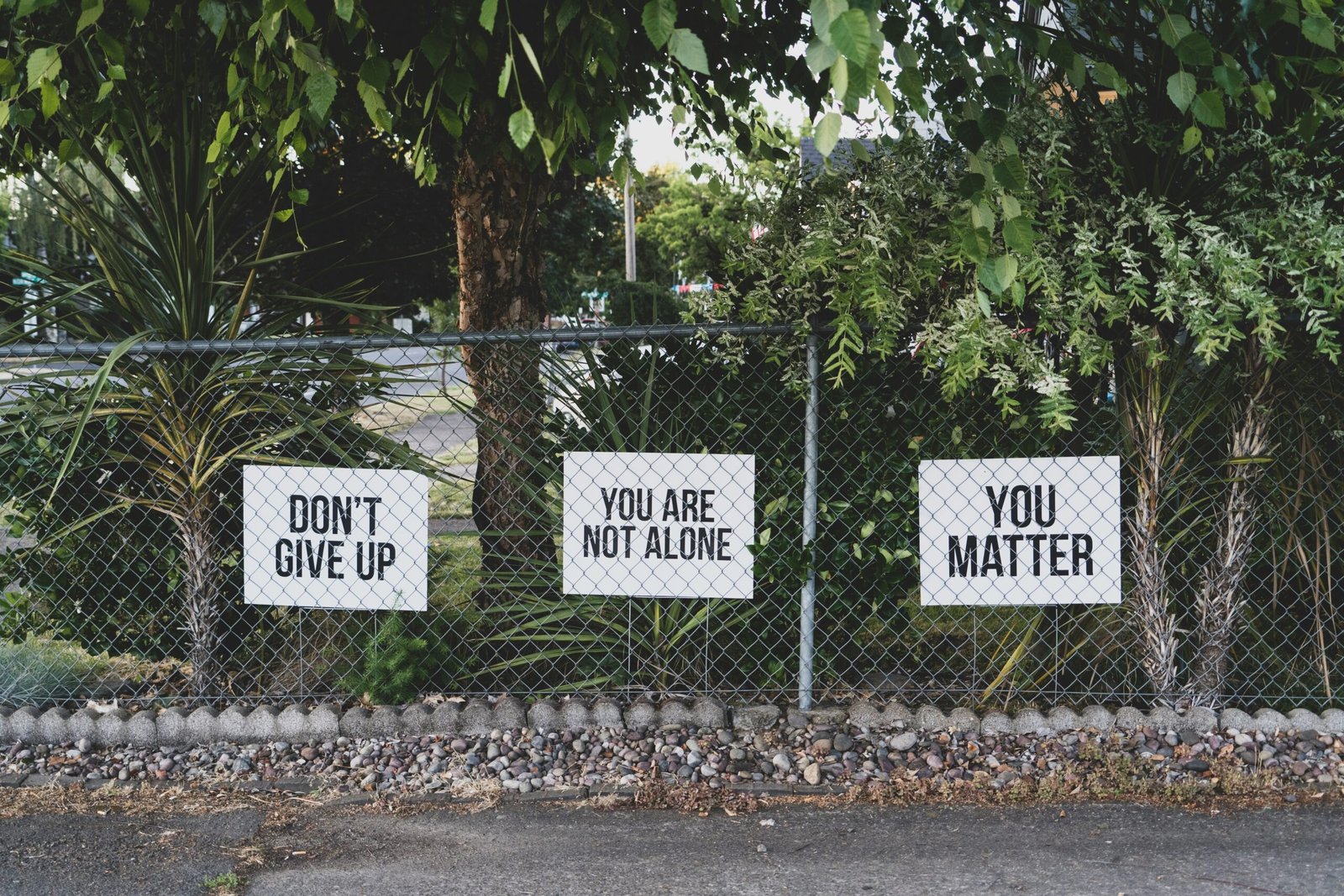 don't give up. you don't give up. You are not alone, you matter signage on metal fence