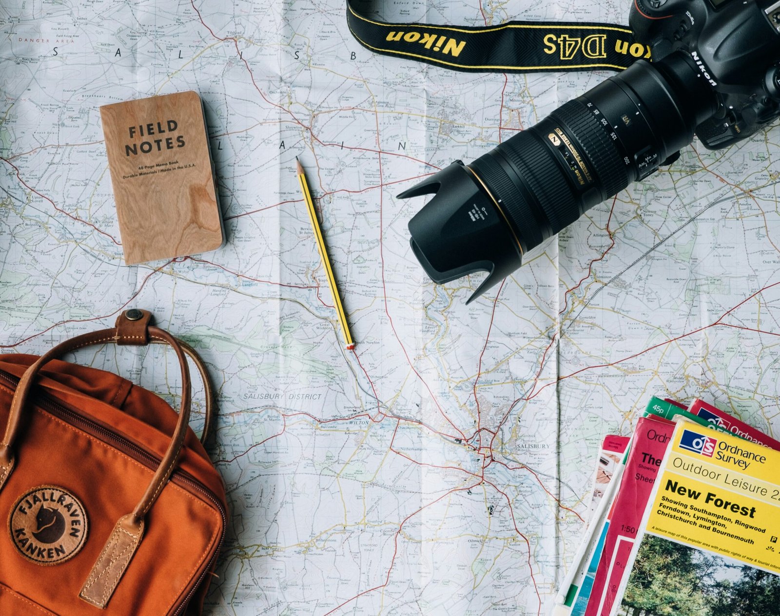 flat lay photography of flat lay photography of camera, book, and bag
