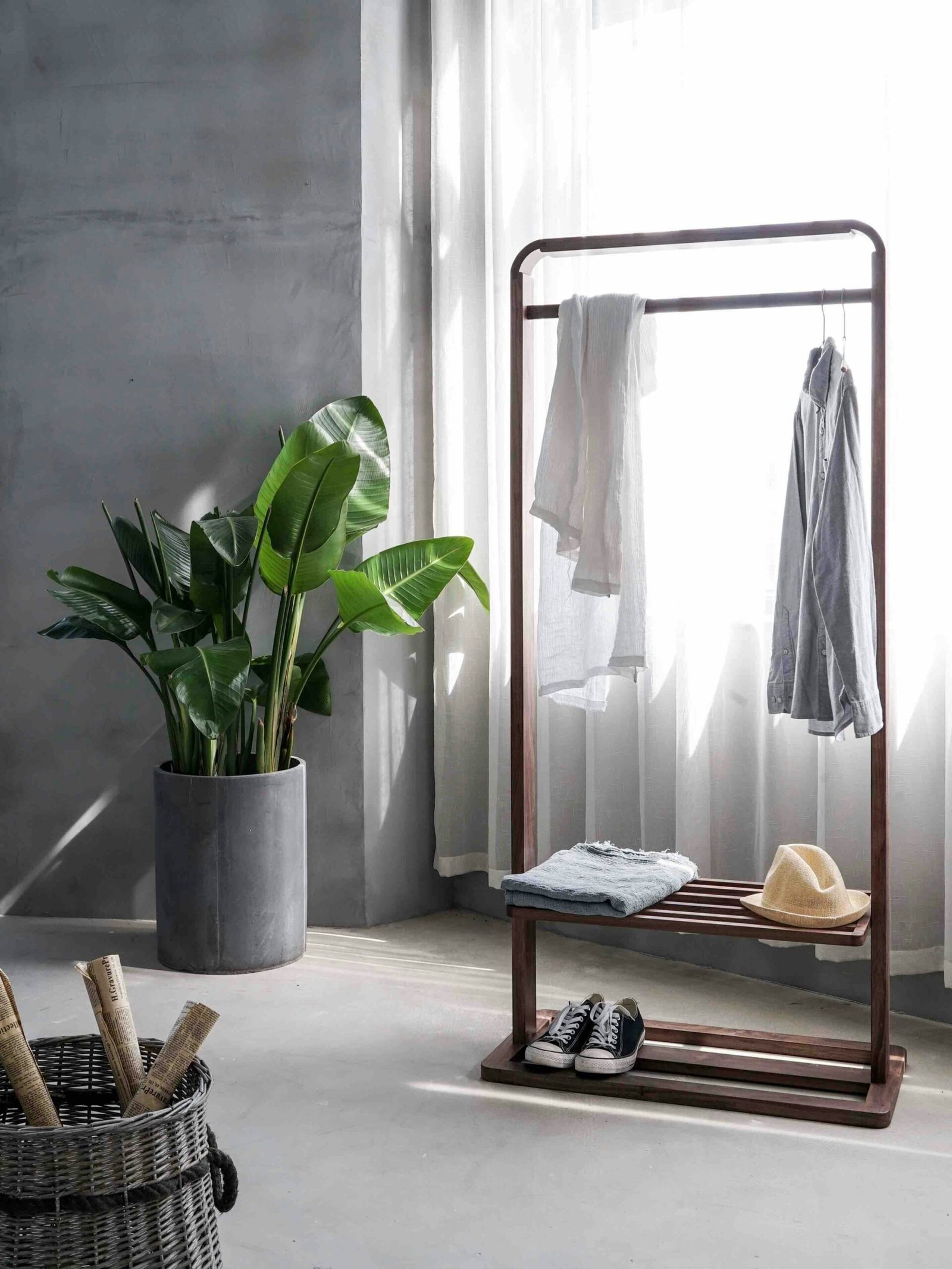 gray dress shirt hang gray dress shirt hang on brown wooden rack in front of window with white curtain