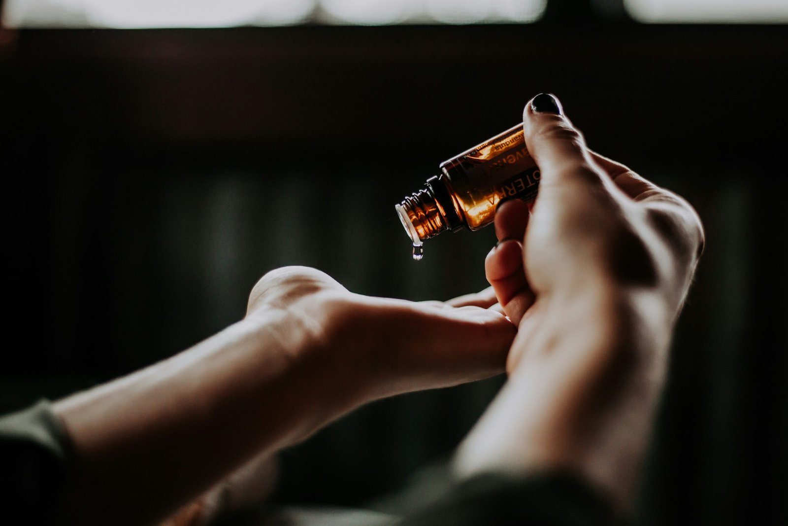 person holding amber glass person holding amber glass bottle