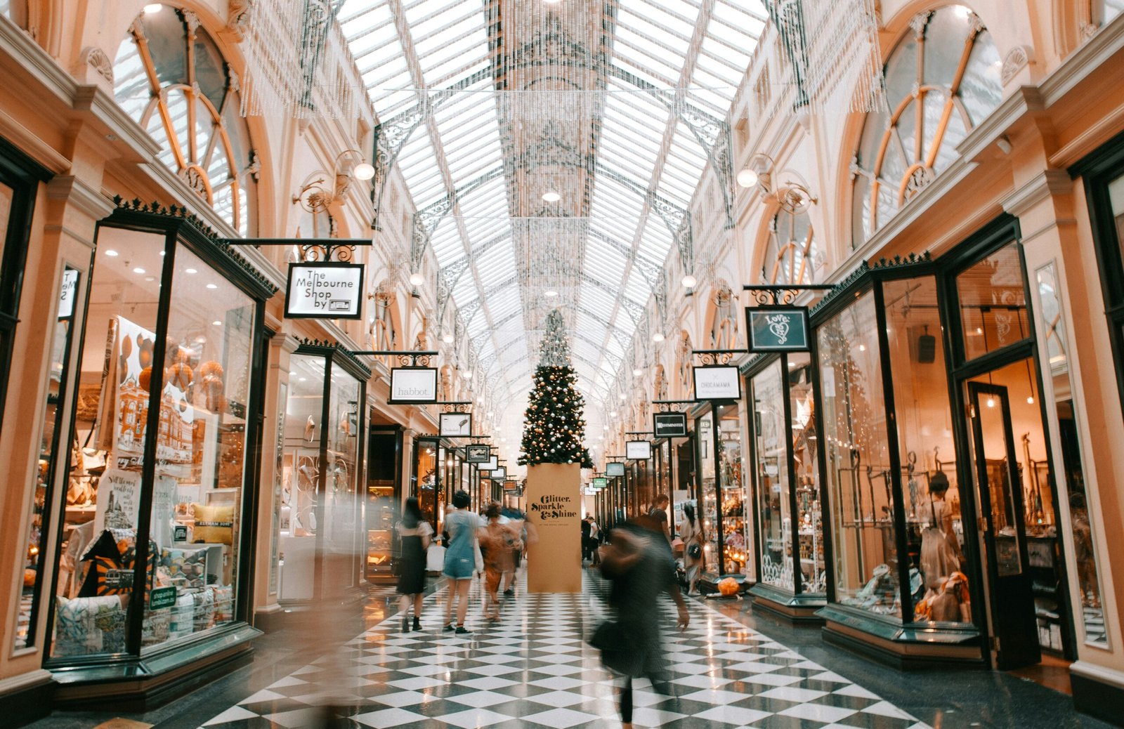 person walking inside building person walking inside building near glass