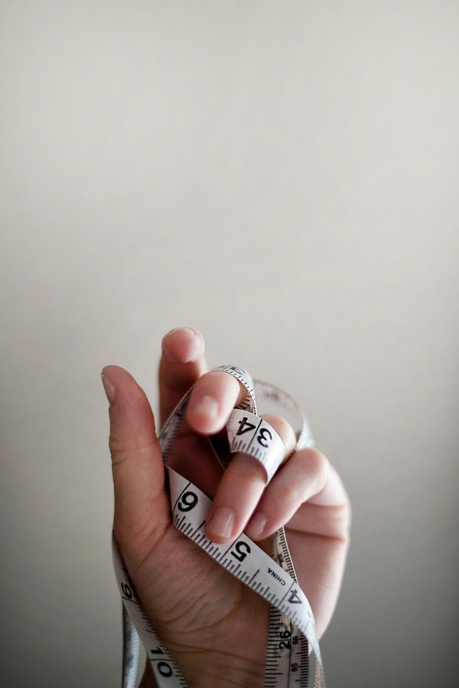 person's left hand wrapped person's left hand wrapped by tape measure