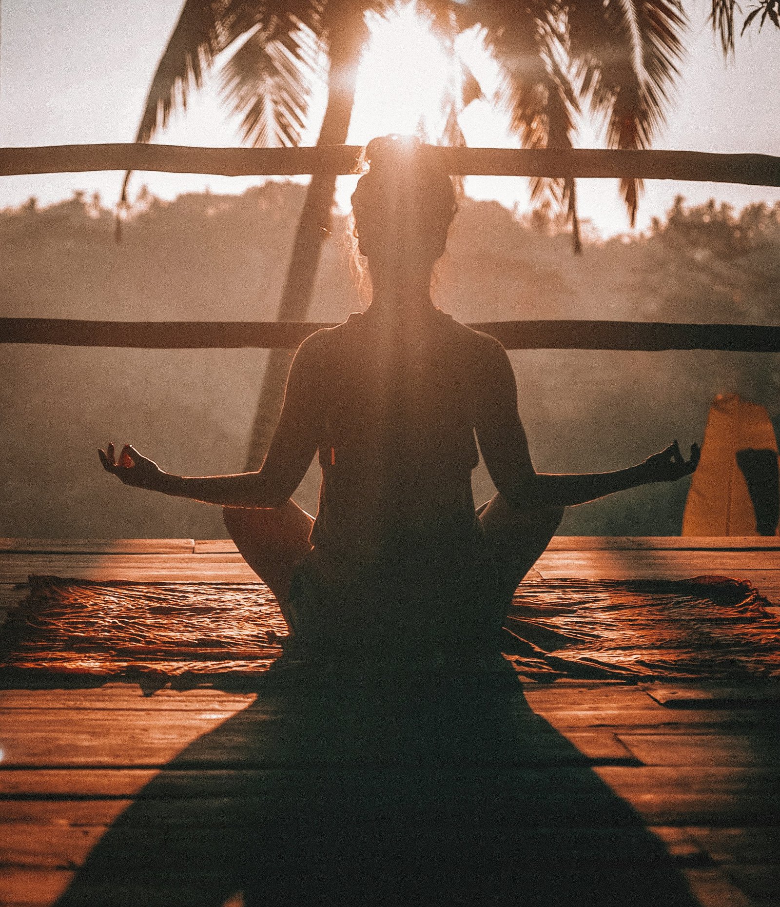 woman doing yoga meditation woman doing yoga meditation on brown parquet flooring