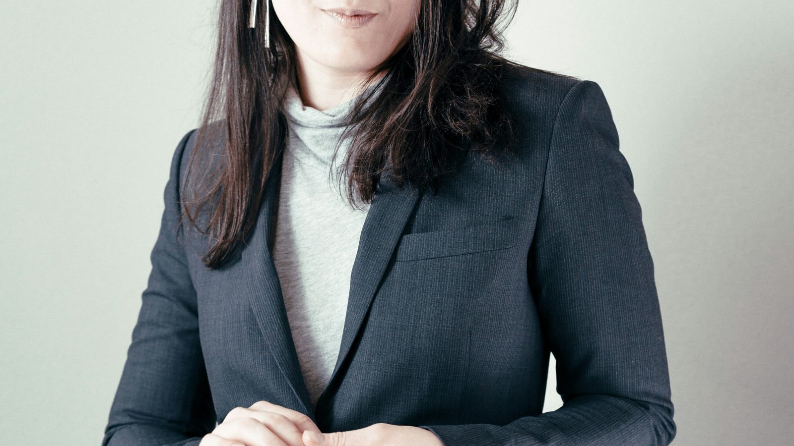 woman in gray turtleneck woman in gray turtleneck sweater and gray blazer