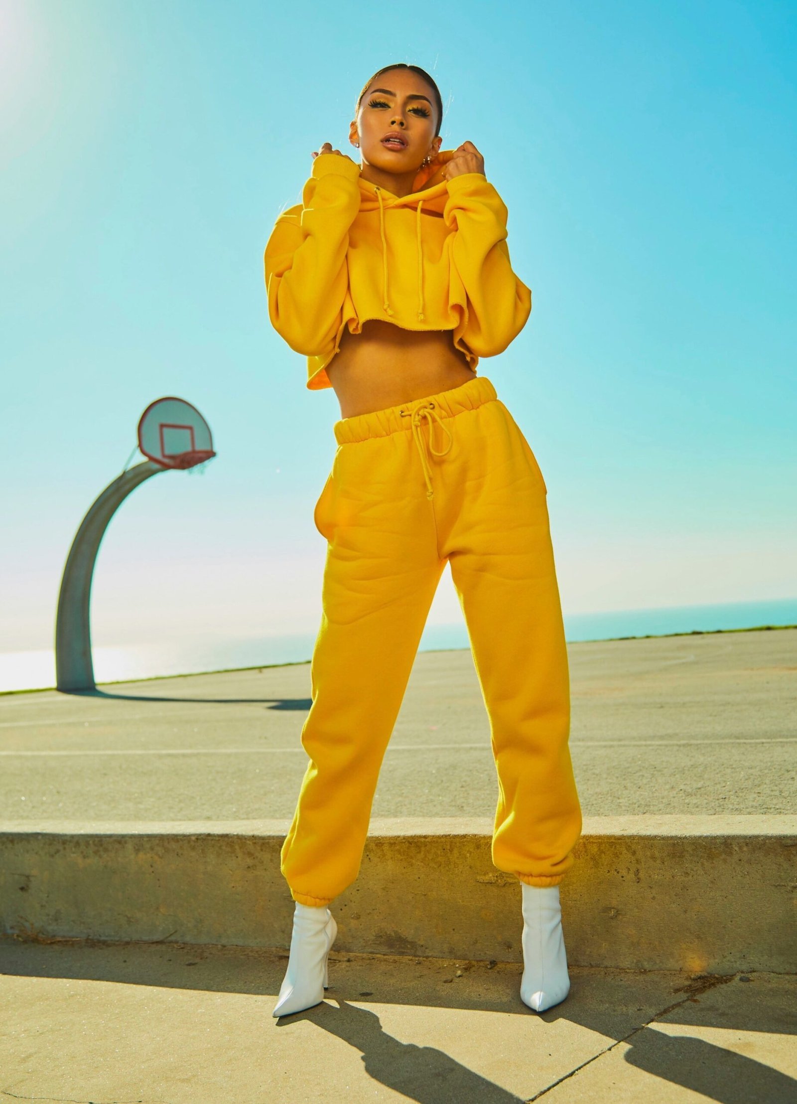 woman in yellow tracksuit woman in yellow tracksuit standing on basketball court side